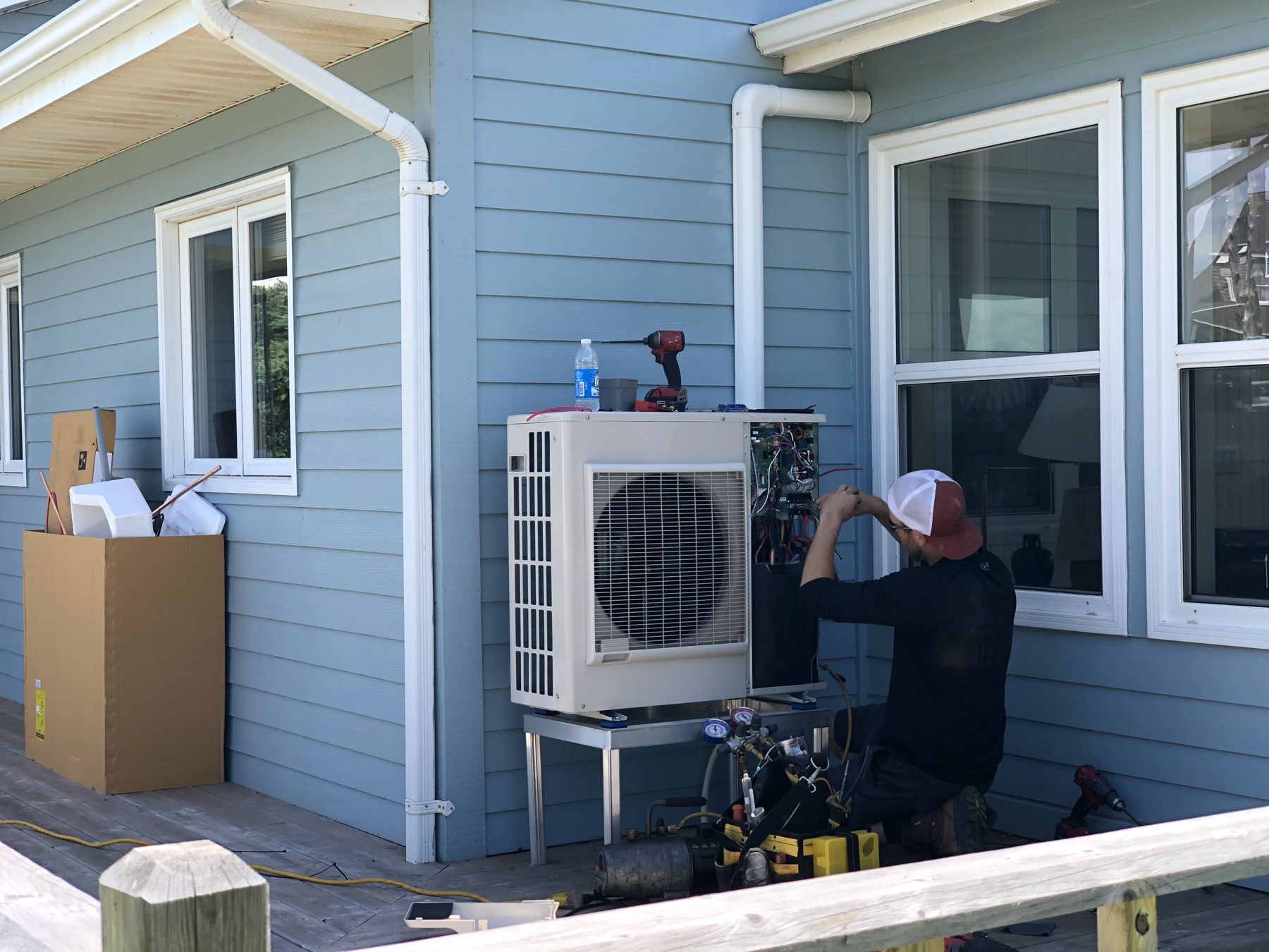 RSI technician installing a heat pump outdoor unit